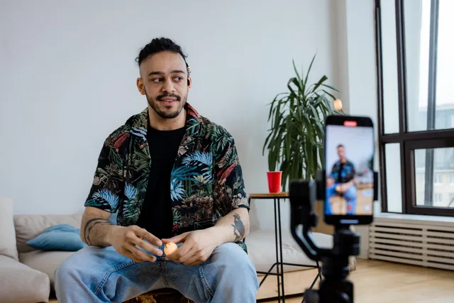 A young man recording video content indoors with a smartphone and tripod. Six UGC strategy mistakes in the exit plan, from no trigger owner to no rehearsal